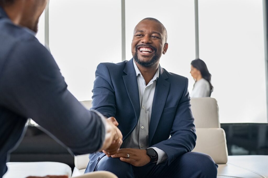 Businessmen shaking hands, a concept of supporting Black-owned businesses.